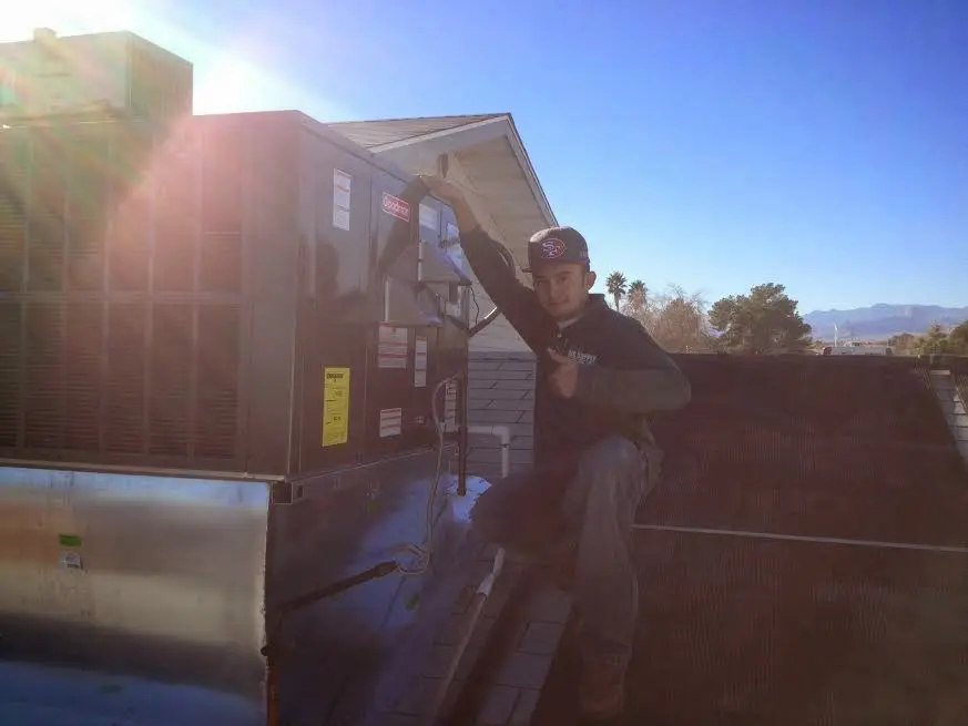 HVAC technician performing Boiler Repair on a rooftop unit in Centralia